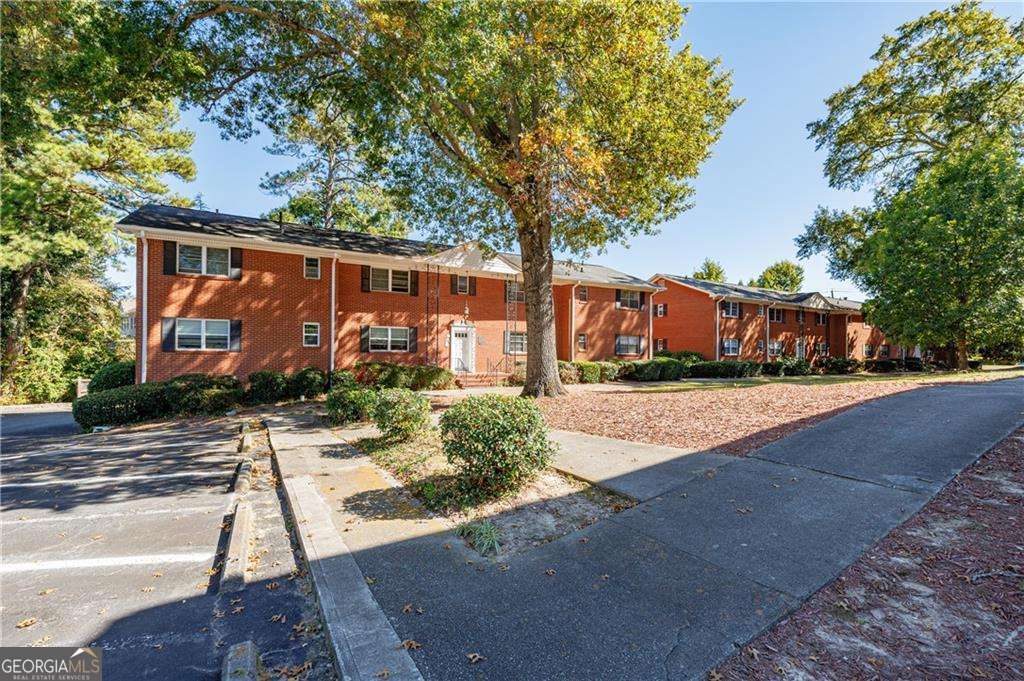 3660 Peachtree Road Northeast, Unit 2H Atlanta, GA 30319 - Photo 6 of 56 a street view with large trees and flower plants
