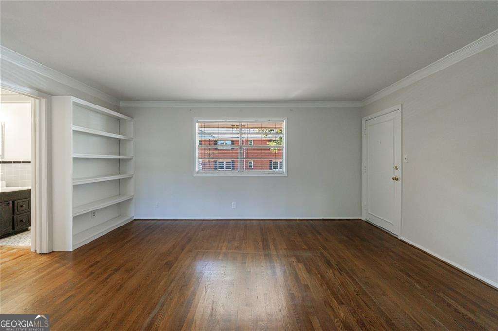 3660 Peachtree Road Northeast, Unit 2H Atlanta, GA 30319 - Photo 10 of 56 a view of a room with wooden floor and a window