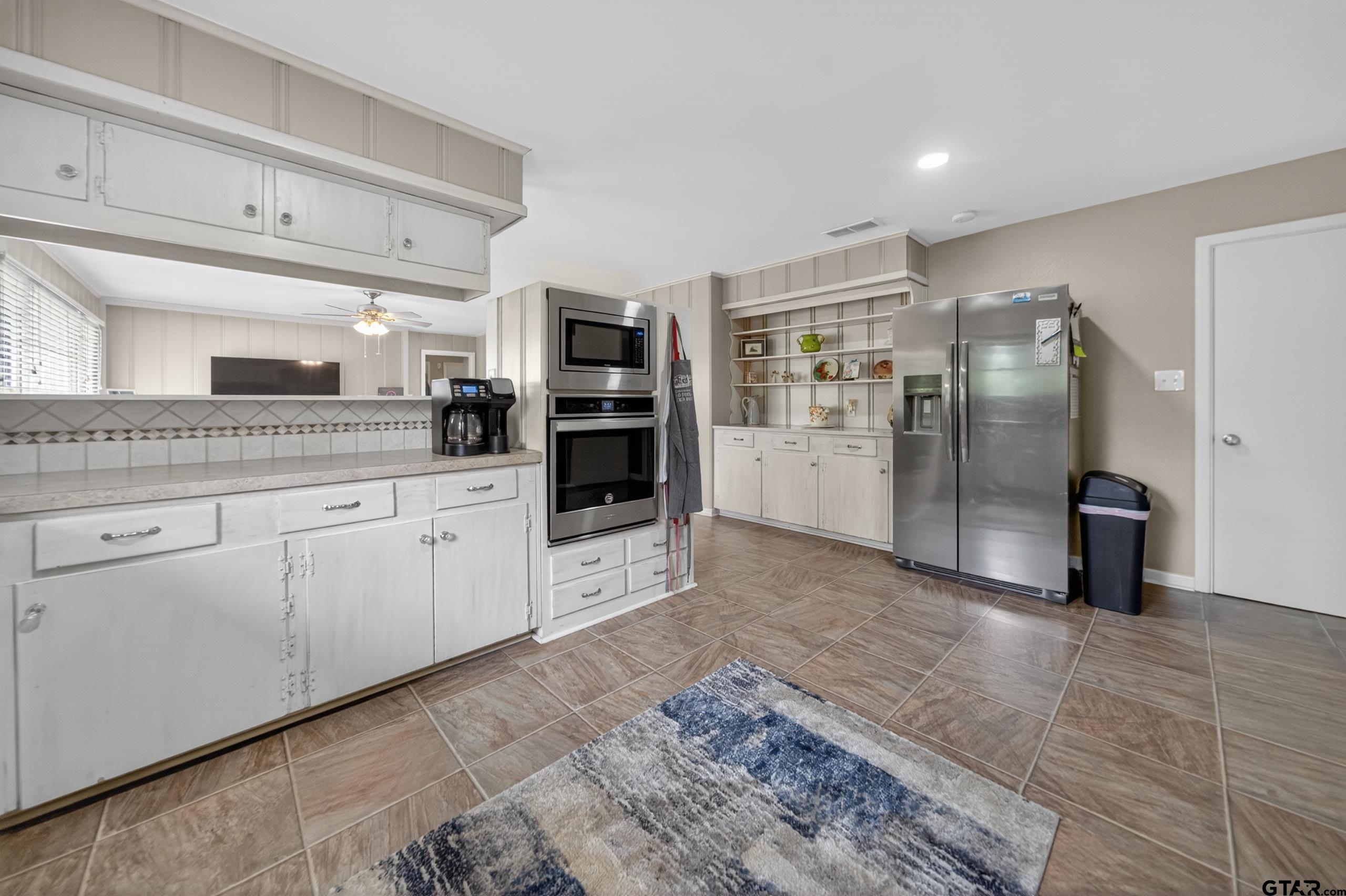 720 Wilma Street Tyler, TX 75701 - Photo 14 of 41 a kitchen with stainless steel appliances a refrigerator sink and cabinets