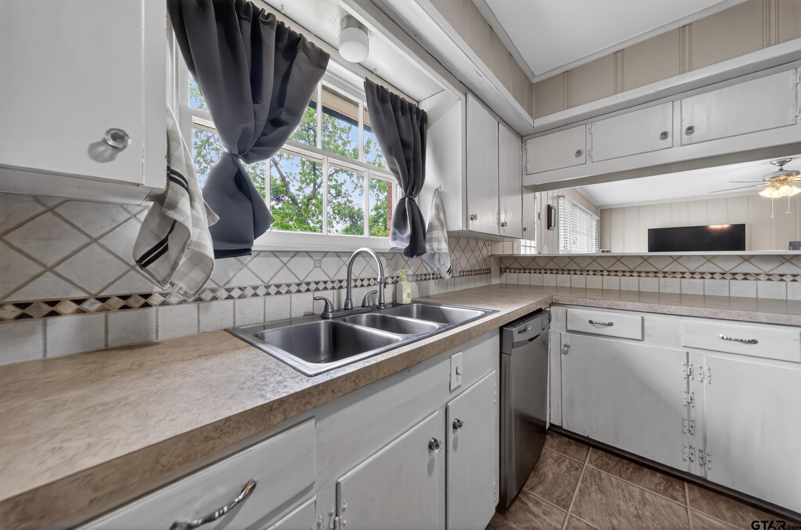 720 Wilma Street Tyler, TX 75701 - Photo 15 of 41 a kitchen with a sink and a white wooden cabinets