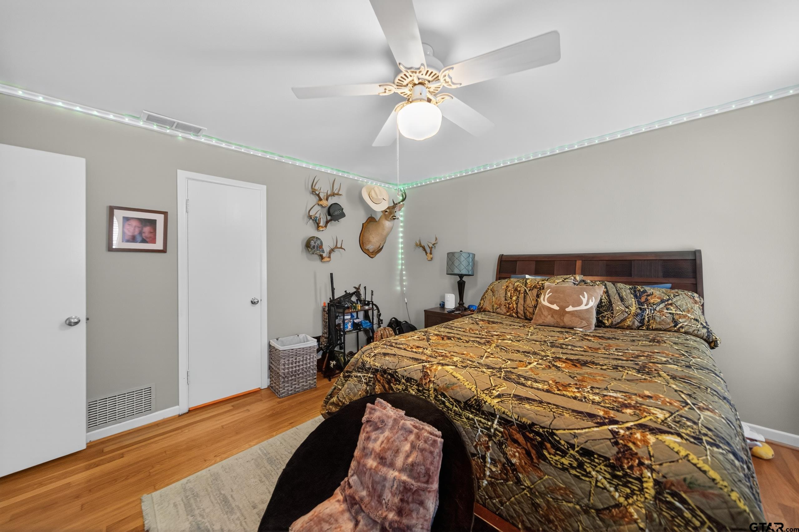 720 Wilma Street Tyler, TX 75701 - Photo 23 of 41 a bedroom with a bed and a chandelier