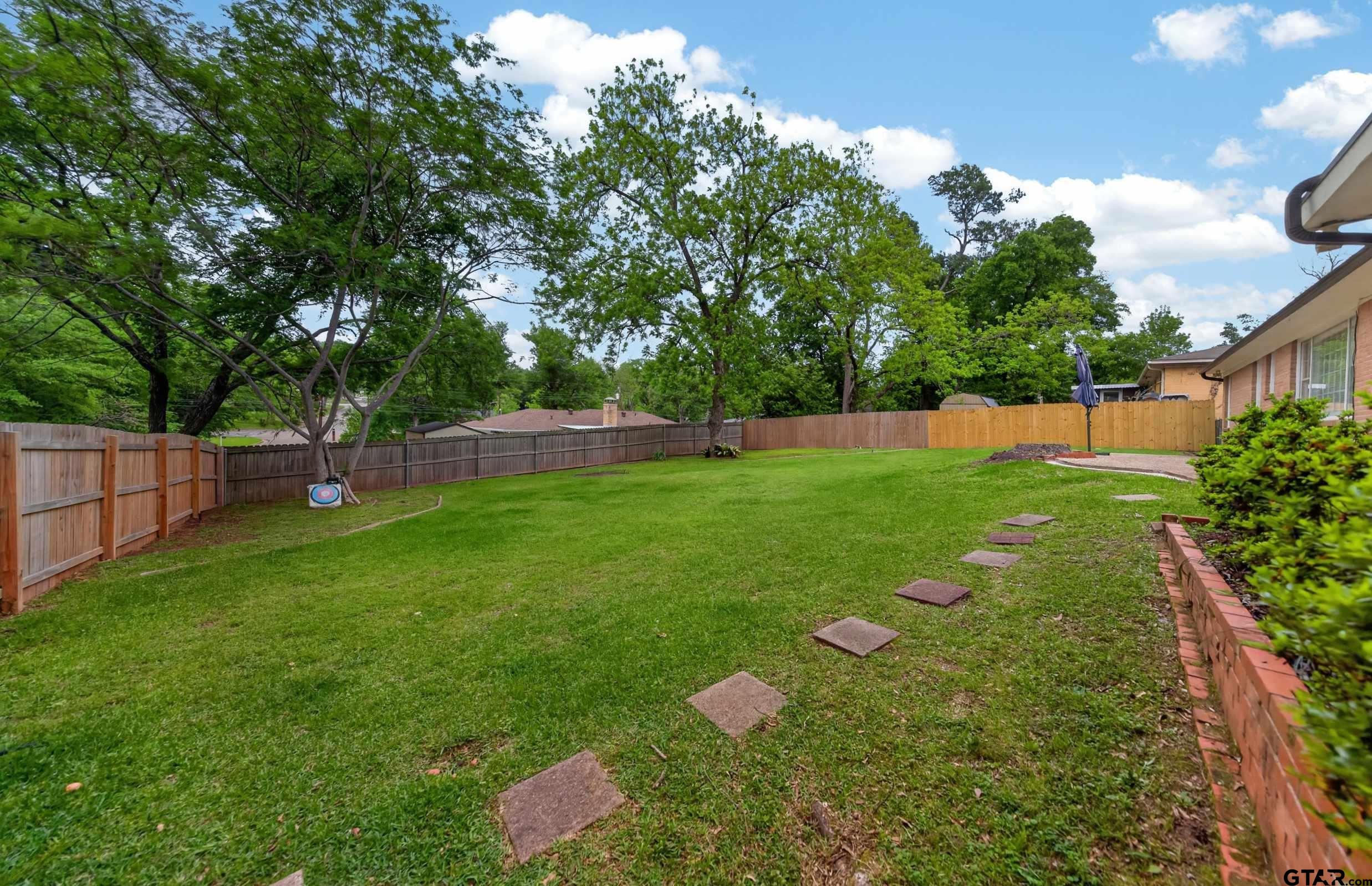 720 Wilma Street Tyler, TX 75701 - Photo 37 of 41 a backyard of a house with lots of green space