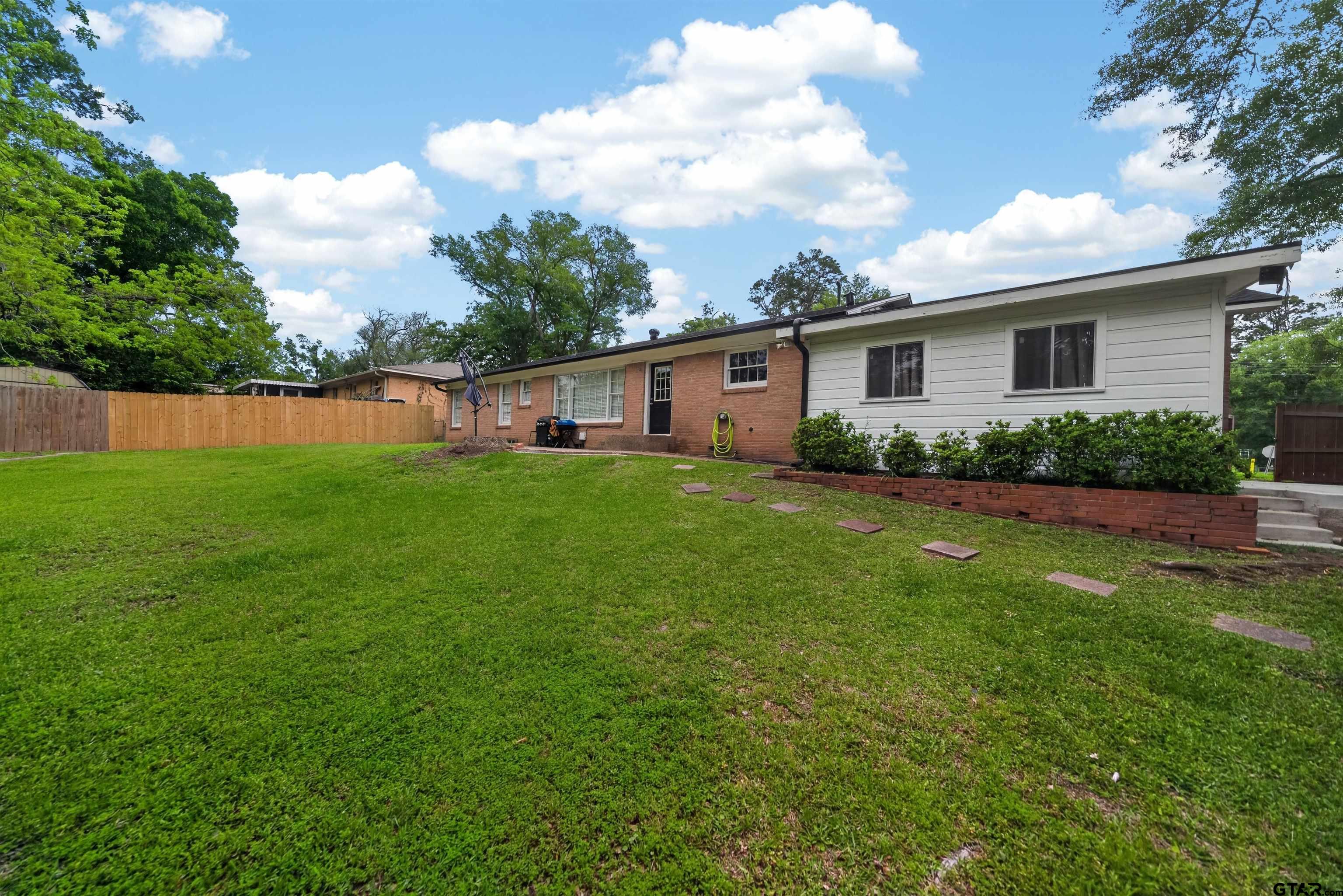 720 Wilma Street Tyler, TX 75701 - Photo 40 of 41 a view of a backyard with plants and a garden