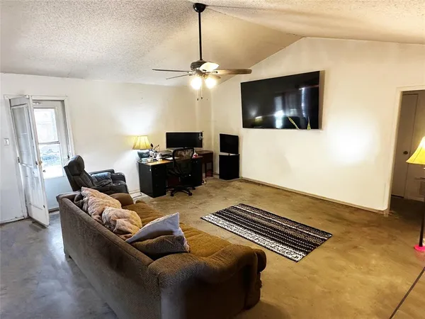 a living room with furniture and a flat screen tv