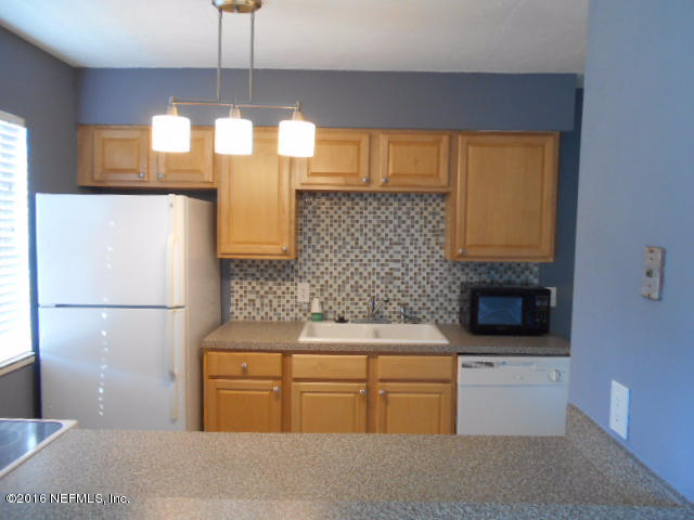 4810 Evenlode Lane Jacksonville, FL 32217 - Photo 10 of 21 a kitchen with a sink stainless steel appliances and cabinets