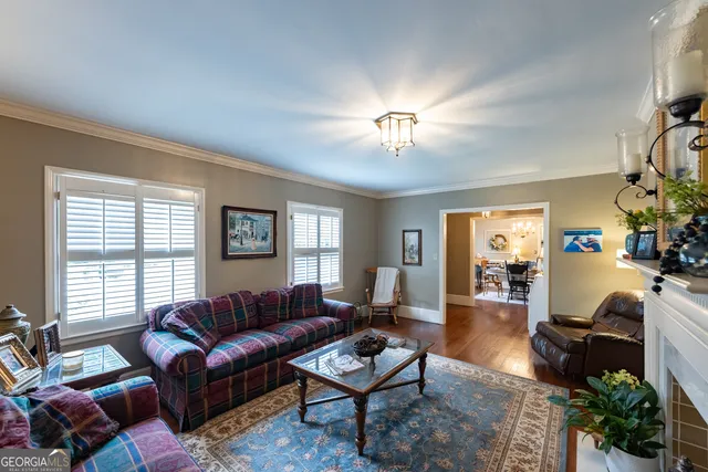 a living room with furniture a chandelier and a window
