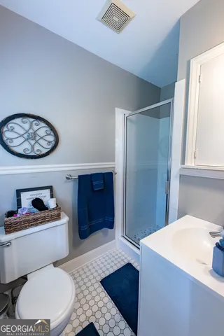 a bathroom with a toilet a sink and a shower