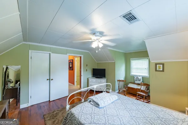 a bedroom with furniture and a chandelier