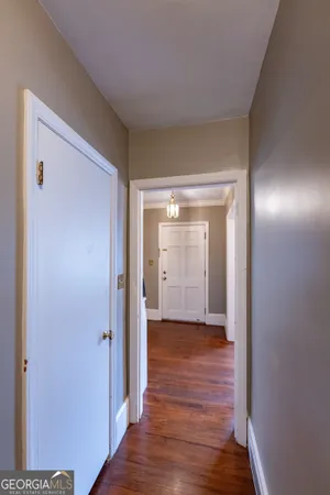a view of a hallway with wooden floor