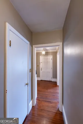 a view of a hallway with wooden floor