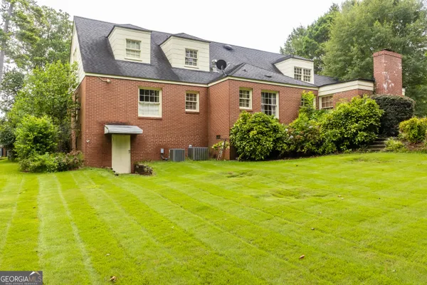 a front view of house with yard and trees