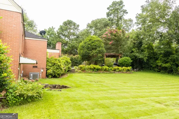 a view of a swimming pool with an outdoor space and seating area