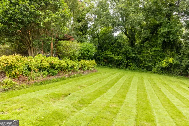 a view of yard with swimming pool