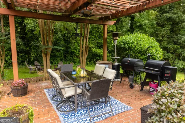 a view of a patio with a dining table and chairs