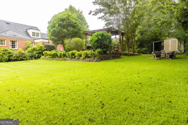 a view of a garden with a house