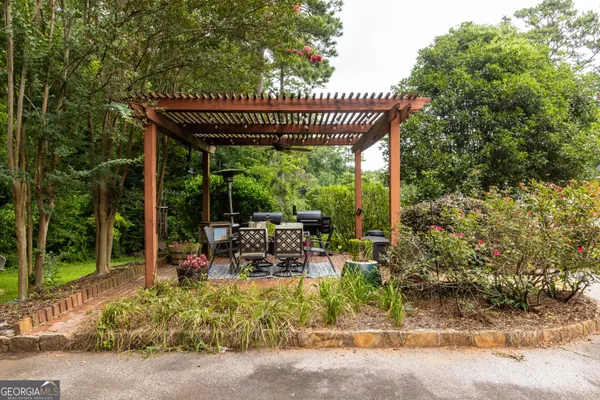a view of a patio with chairs in front of house