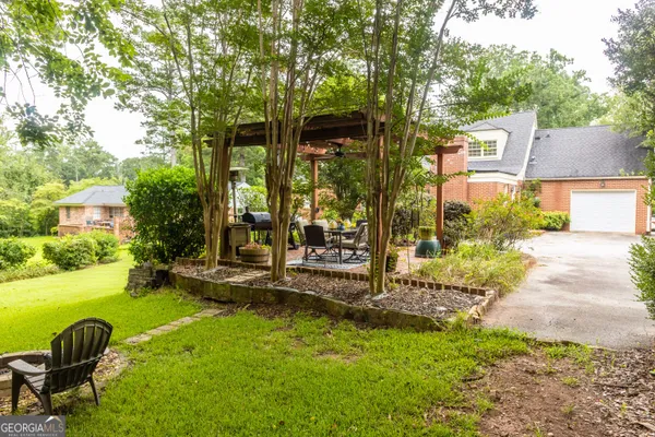 a view of a house with backyard porch and sitting area