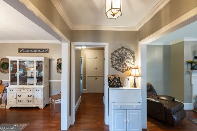 a view of a hallway to a livingroom with furniture