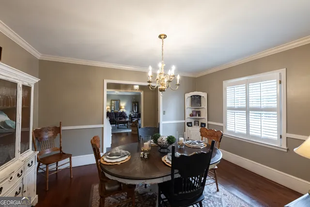a view of a dining room with furniture and chandelier