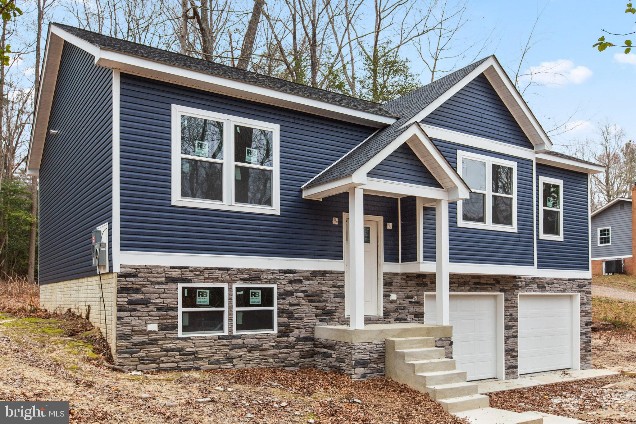 23570 Myrtle Point Road California, MD 20619 - Photo 15 of 18 a front view of a house with a yard