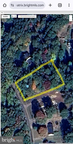 a view of a yard with wooden fence