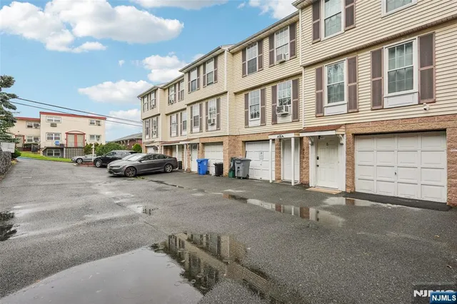 a building with car parked in front of it