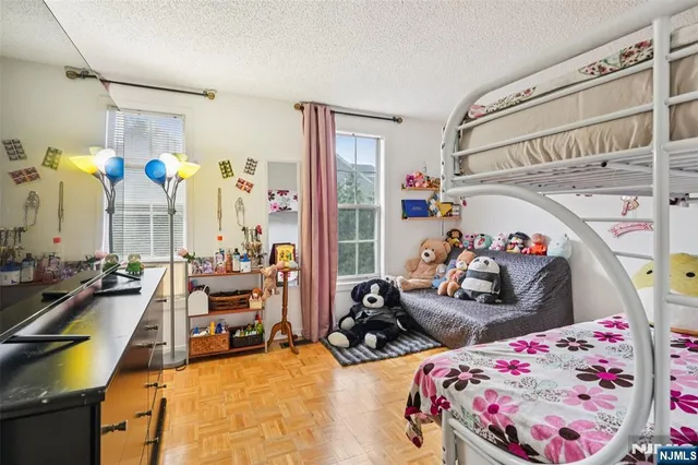 a bed room with two beds and a chandelier