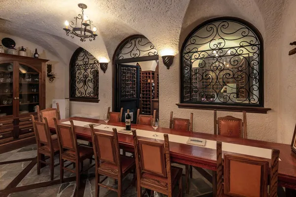 a dining room with furniture a chandelier and wooden floor