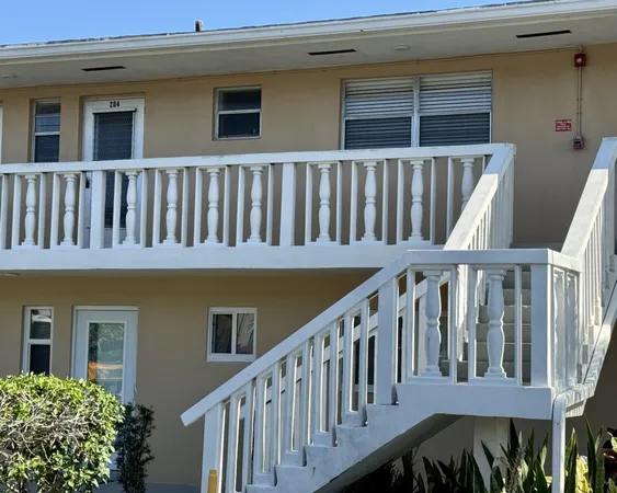 a balcony with wooden floor and fence