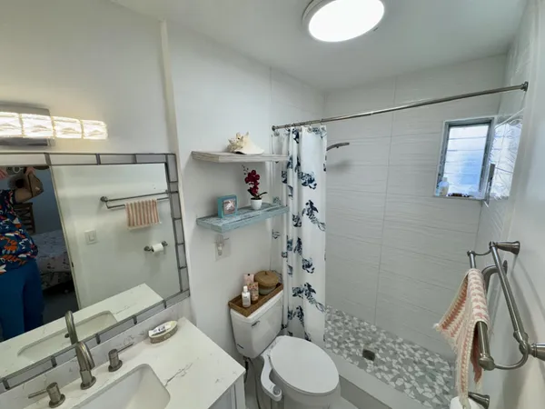 a bathroom with a sink toilet and shower