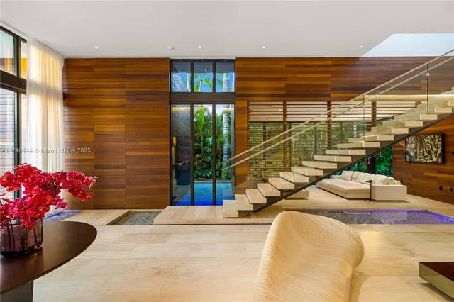 a living room with patio furniture and garden