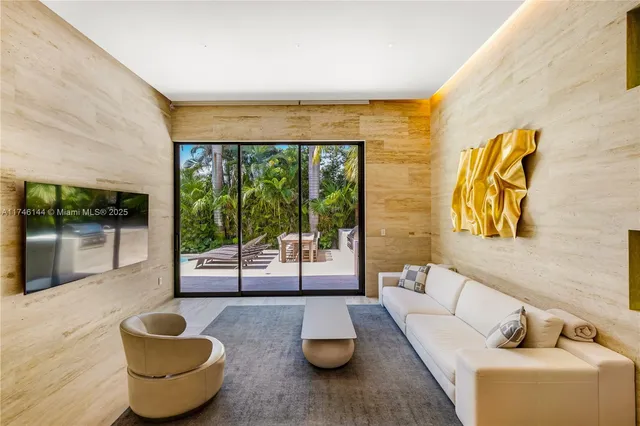 a view of a patio with a table and chairs under an umbrella