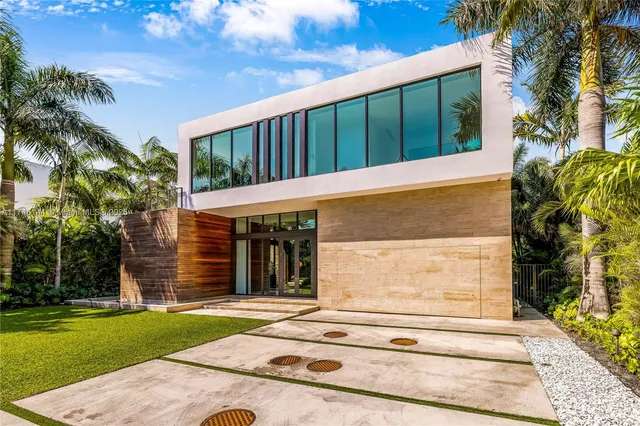 a view of a hallway with furniture and a chandelier