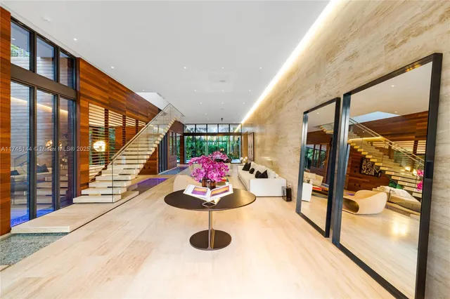 a living room with furniture gym equipment and a large window