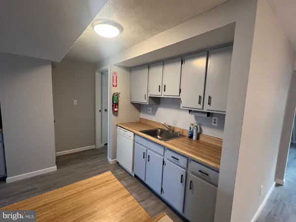 a view of a room with wooden floor and a window