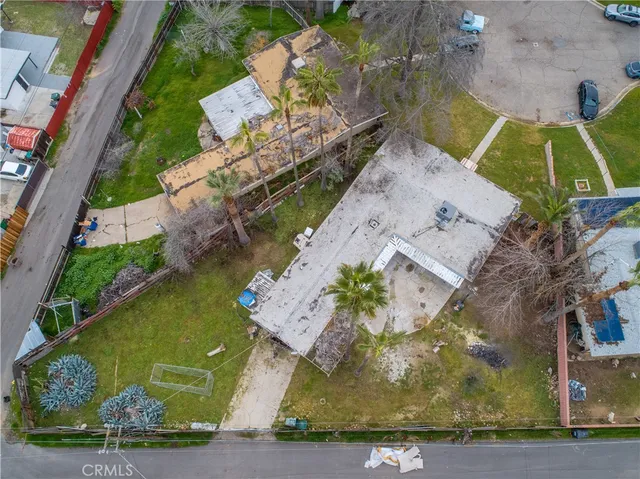 an aerial view of a house with a yard