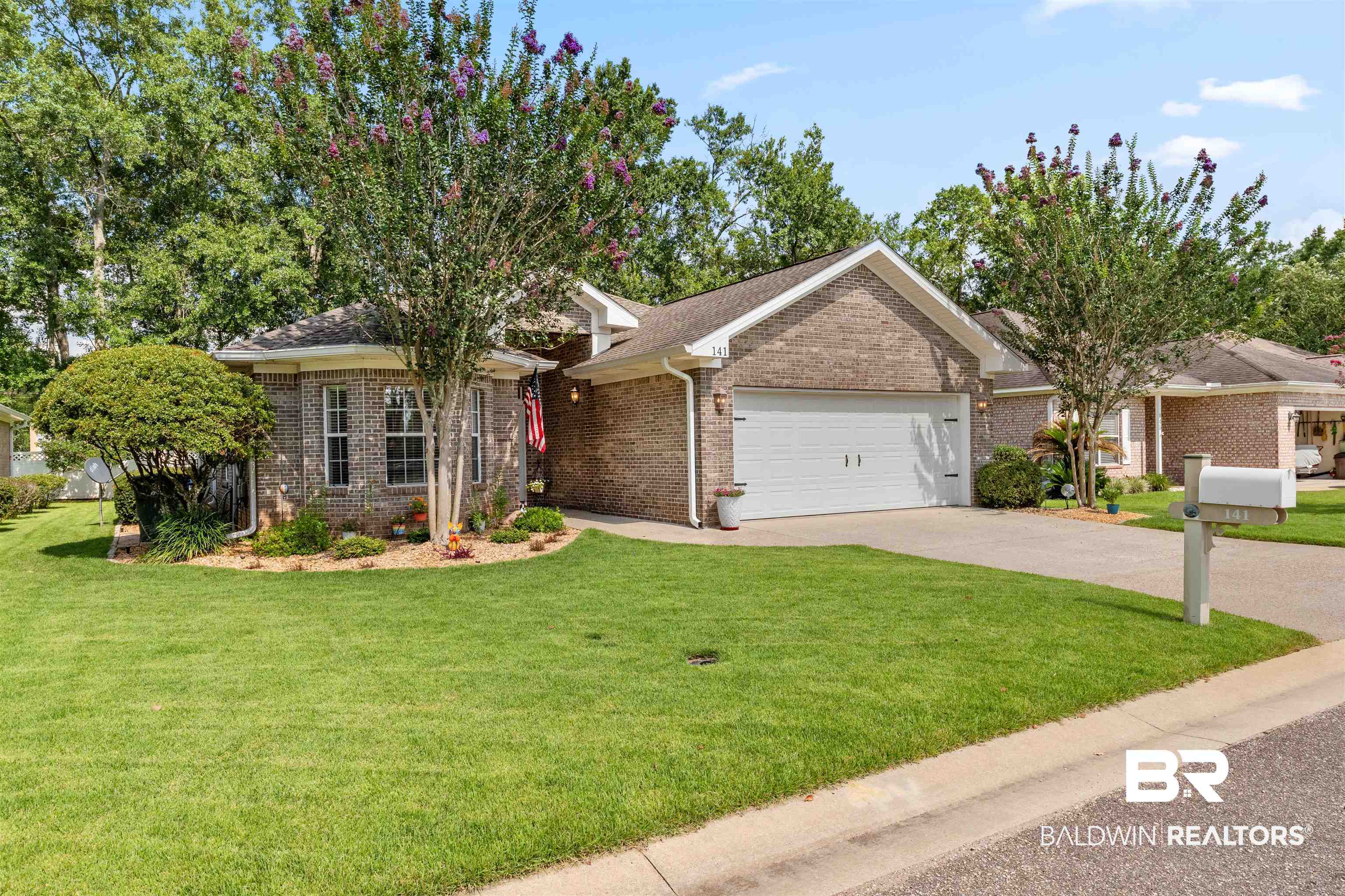 141 Mark Twain Loop Foley, AL 36535 - Photo 46 of 55 Single story home featuring a garage, brick siding, driveway, and a front yard
