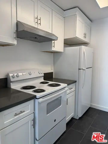 a kitchen with a stove and a refrigerator