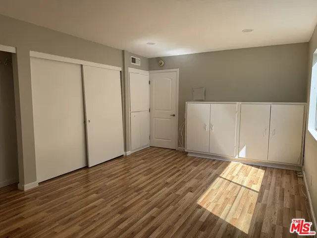 a view of an empty room and wooden floor