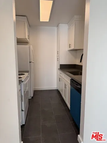 a kitchen with a stove and a refrigerator