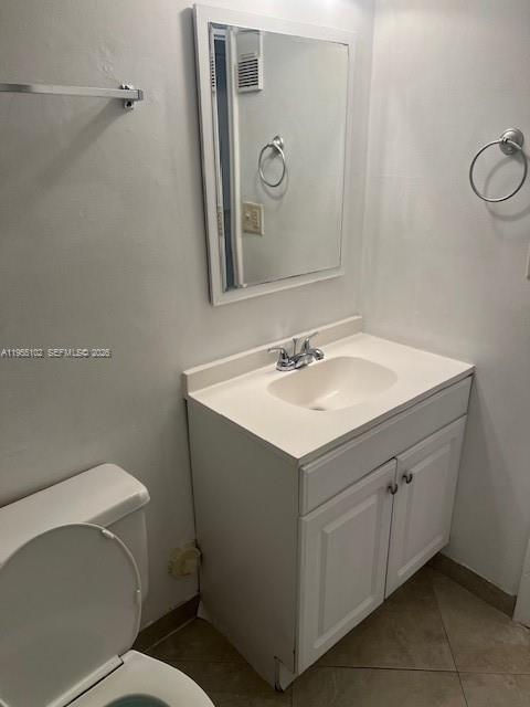 2401 Riverside Drive, Unit 110B Coral Springs, FL 33065 - Photo 16 of 27 a bathroom with a sink mirror vanity and toilet