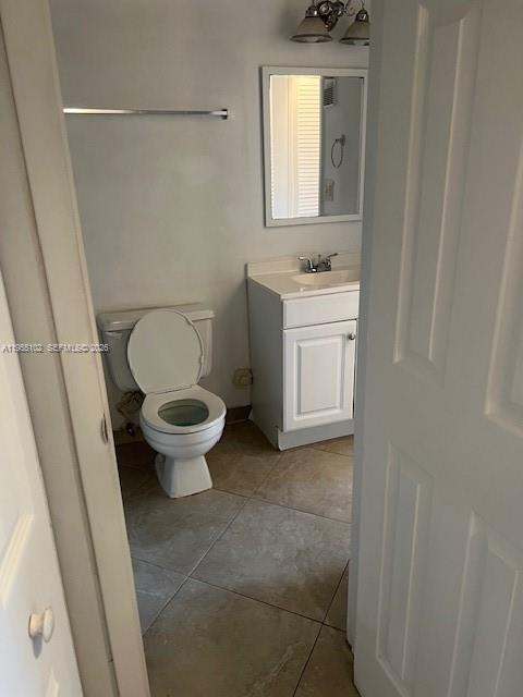 2401 Riverside Drive, Unit 110B Coral Springs, FL 33065 - Photo 19 of 27 a bathroom with a sink a toilet and a mirror