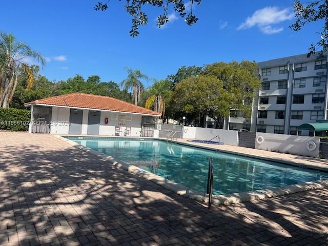 2401 Riverside Drive, Unit 110B Coral Springs, FL 33065 - Photo 20 of 27 a front view of a house with garden