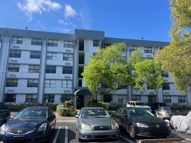 2401 Riverside Drive, Unit 110B Coral Springs, FL 33065 - Photo 3 of 27 a front view of a house with cars parked