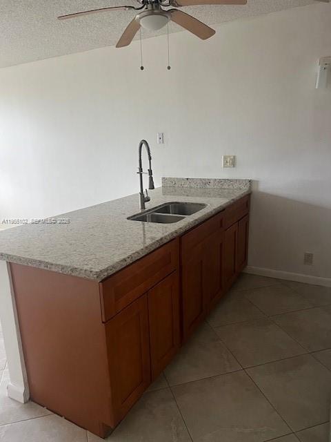 2401 Riverside Drive, Unit 110B Coral Springs, FL 33065 - Photo 6 of 27 a kitchen with a sink a stove and cabinets