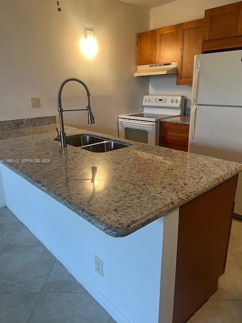 2401 Riverside Drive, Unit 110B Coral Springs, FL 33065 - Photo 7 of 27 a kitchen with stainless steel appliances granite countertop a sink a stove and microwave