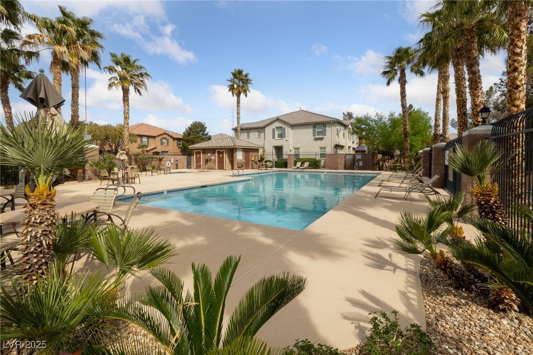 9121 Ripple Ridge Avenue, Unit 101 Las Vegas, NV 89149 - Photo 13 of 16 Community pool featuring a patio area and a residential view