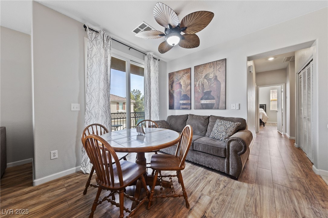 9121 Ripple Ridge Avenue, Unit 101 Las Vegas, NV 89149 - Photo 7 of 16 Dining room featuring wood finished floors and ceiling fan