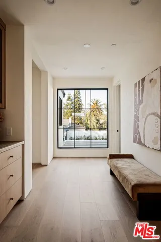 a living room with hard wood floors and a large window
