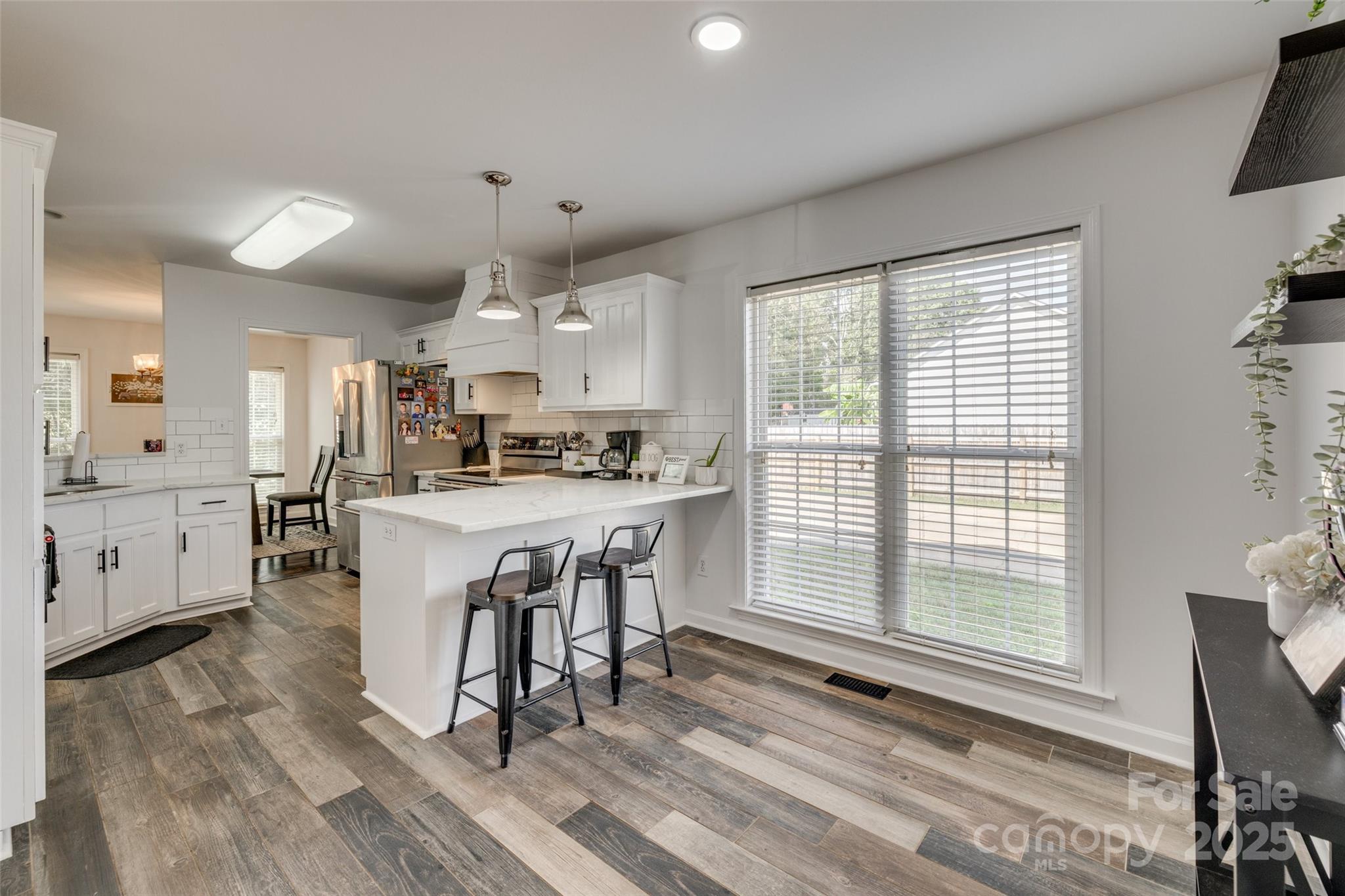 1140 Landsdown Drive Salisbury, NC 28147 - Photo 12 of 37 a kitchen with kitchen island granite countertop a sink cabinets and wooden floor